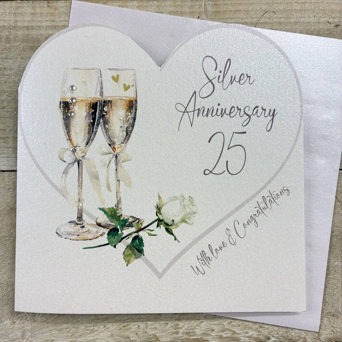 Anniversary Card: Silver 25th Cut Out Heart With Champagne Glasses  - White Cotton Cards