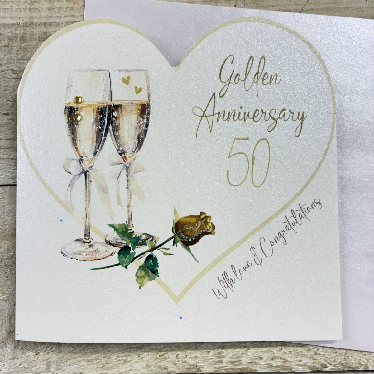 Anniversary Card: Golden 50th Cut Out Heart With Champagne Glasses - White Cotton Cards
